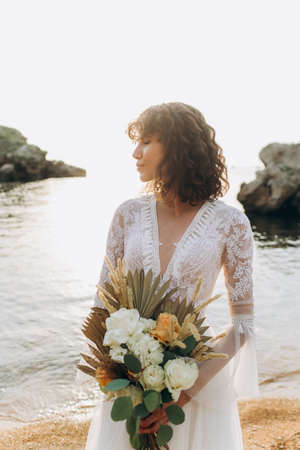 Boho bouquet of roses in the hands of the bride.の写真素材