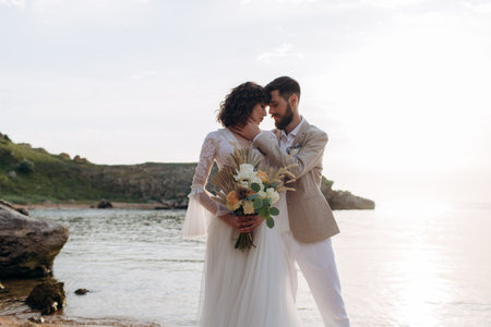 Wedding on the sunset with live floristry. Bride and groom in boho style.の写真素材