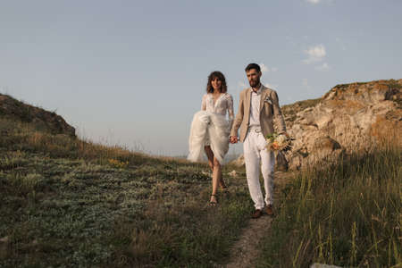Wedding on the sunset. Bride and groom in boho style.の写真素材