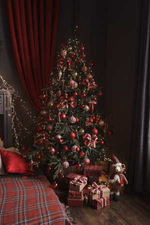 New Year and Christmas gifts under the tree in red paper.の写真素材