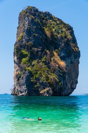 Snorkeling at the beach with limestone mountain backgroundの写真素材