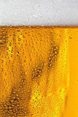 Bubbles and foam in a beerの写真素材