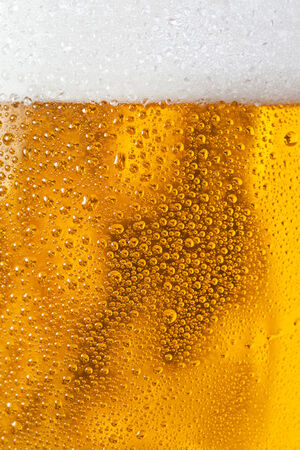 Bubbles and foam in a beerの写真素材