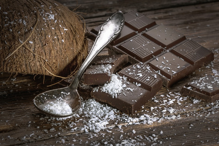 Chocolate and coconut on old tableの写真素材