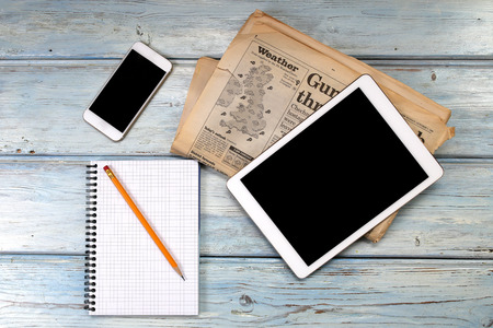 Tablet and coffee on wooden table