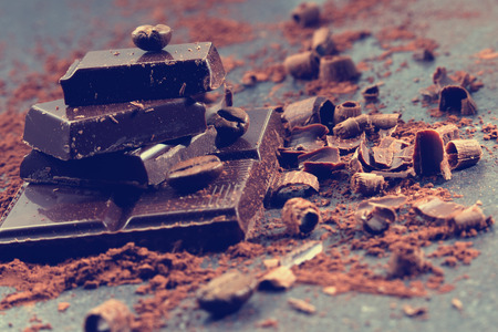 Dark chocolate and coffee beans on a stone tableの写真素材