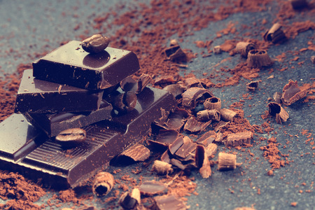 Dark chocolate and coffee beans on a stone tableの写真素材