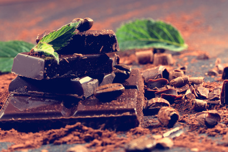 Dark chocolate and coffee beans on a stone table