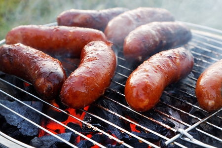 Grilling sausages on barbecue grillの写真素材