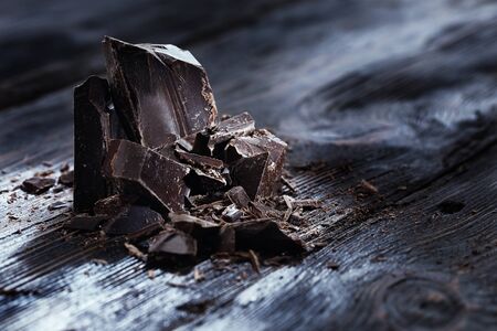 Chocolate pieces on a wooden tableの写真素材