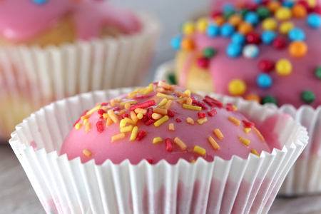 Sweet homemade cupcakes on a wooden tableの写真素材