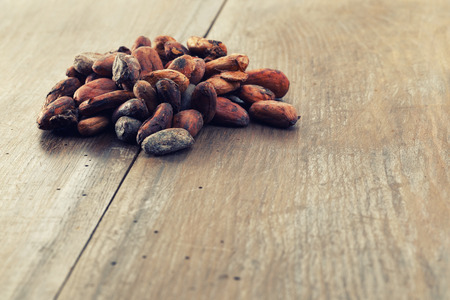 Cocoa beans on a wooden tableの写真素材
