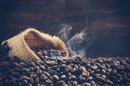 Vintage photo of roasting coffee beans with smokeの写真素材