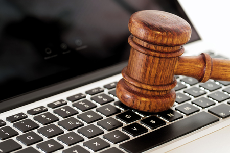 Wooden hammer law on computer keyboardの写真素材