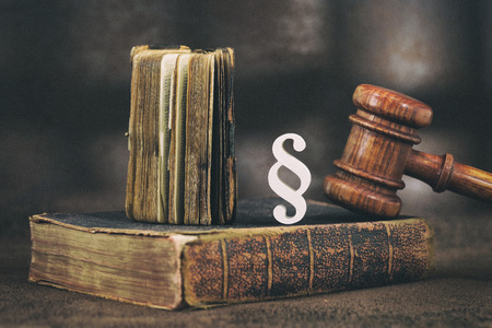 Law gavel on old brown leather book