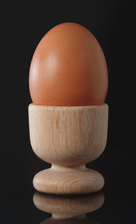 Chicken Egg in Egg Cup Isolated on black Background