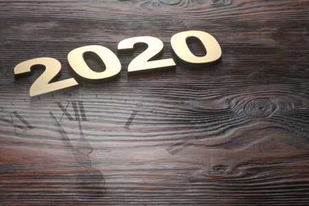 Happy New Year 2020. Symbol from number 2020 on wooden background