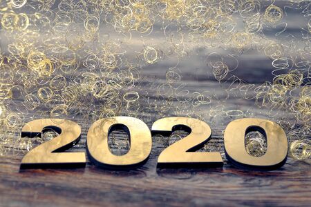 Happy New Year 2020. Symbol from number 2020 on wooden background