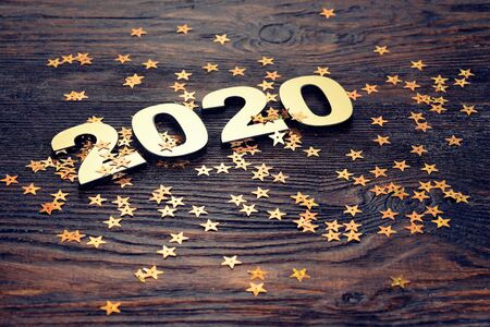 Happy New Year 2020. Symbol from number 2020 on wooden background