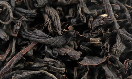 Premium black loose leaf tea as a background. Texture of dry black tea leaves. Extreme macro modeの写真素材