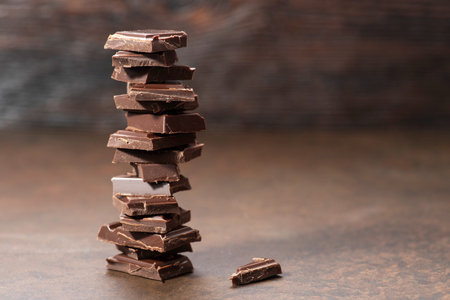 Chocolate stack on wooden background. Shallow depth of field.の写真素材