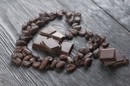 Cocoa beans and chocolate on wooden background, closeup.の写真素材