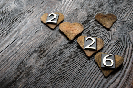 Wooden hearts on grey wooden background. Copy space.
