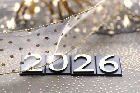 New Year's card with numbers 2026 on a background of silver fabric