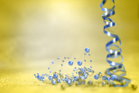 Celebration background with blue ribbons and serpentine on yellowの写真素材