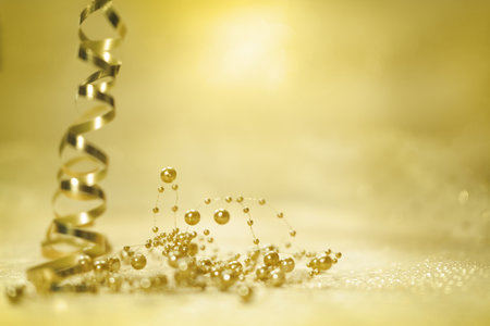golden streamer and christmas decoration on bokeh backgroundの写真素材