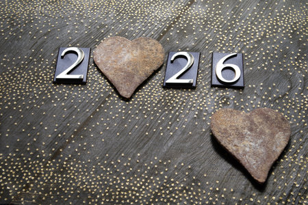 Happy new year with hearts on wooden background. Selective focus.の写真素材