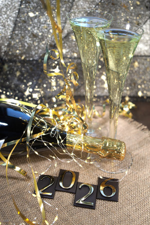 New Year's Eve celebration with champagne glasses and gold confetti.