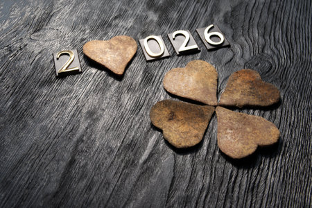 Happy new year with hearts on wooden background.