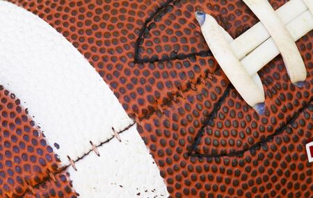 close up of football with laces and stripesの写真素材