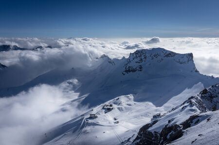 View from the tallest mountain in Germany on the cloudy surrounding, sun from above