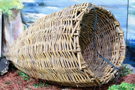 Wicker fishing tackle. On the table with a blue backgroundの写真素材