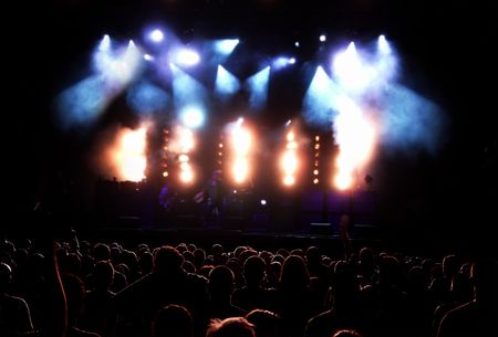 Concert Audience (People Silhouettes Against Lit Stage At The Rock Concert)