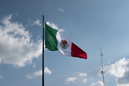 Mexican flag on a flagpole in the center of Leon Guanajuatoの写真素材