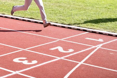 close up runners on on finishing line