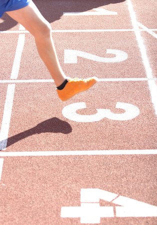 close up runners on on finishing lineの写真素材