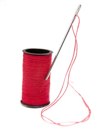 red thread bobbin and needle on white background with path