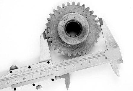 vernier measuring tool scale and mechanical machine part on white backgroundの写真素材