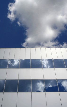 detail of office building and deep blue sky and white cloudsの写真素材