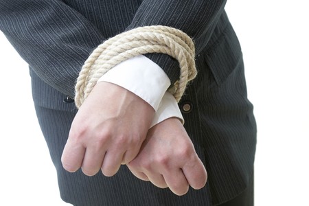 close up of businesswoman hands tied with rope