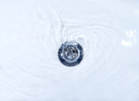 close up of drain and water in bathroomの写真素材