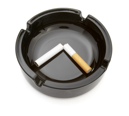 close up of ashtray and cigarette on white backgroundの写真素材