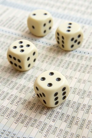 close up of stock market numbers  in papers and dice