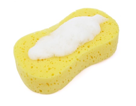 close up of kitchen sponge with foam for do the dishes on white background with pathの写真素材