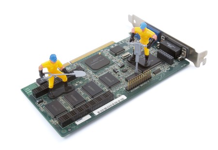 close up of computer parts and toy workers on white backgroundの写真素材