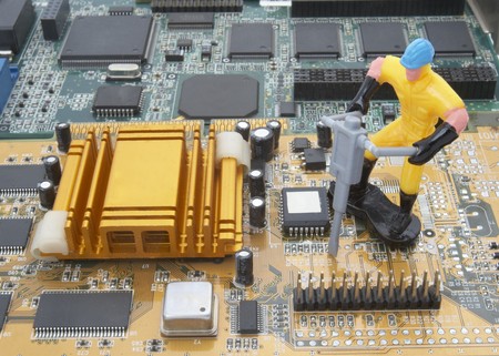 close up of computer parts and toy workers